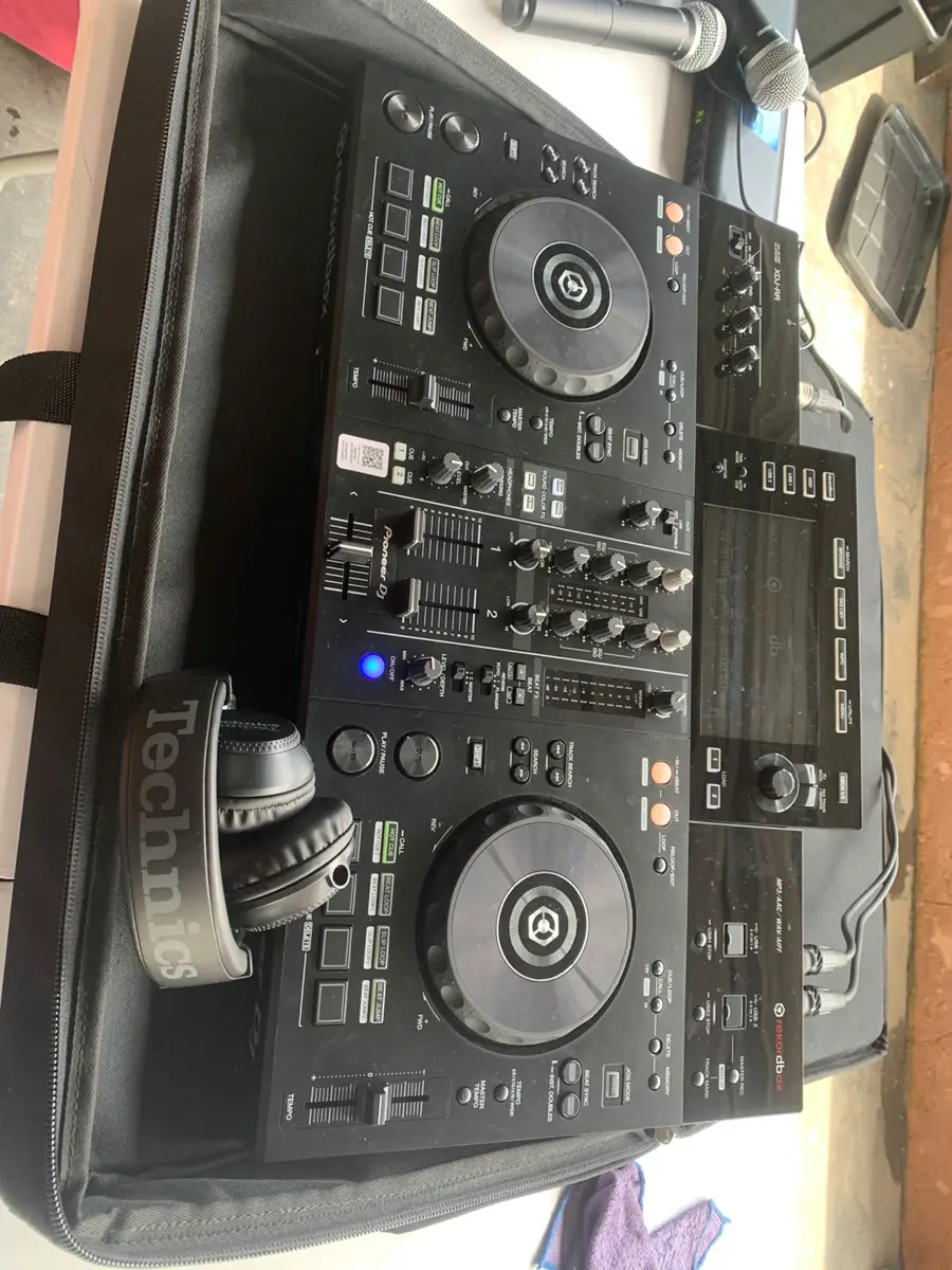 Professional DJ controller in an open carrying case with Technics headphones